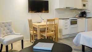 A modern kitchen with white cabinets, a built-in oven, and a microwave. - Skistar 105 by Interhome (Kittilä)