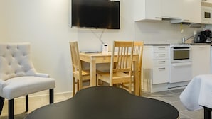 A modern kitchen with white cabinets, a built-in oven, and a microwave. - Skistar 105 by Interhome (Kittilä)