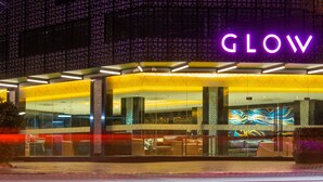 A hotel exterior with a neon sign reading "GLOW" and a modern glass facade. - GLOW Pattaya (Pattaya)