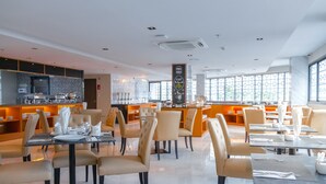 A modern restaurant with a bar area, multiple dining tables, and chairs. - GLOW Pattaya (Pattaya)