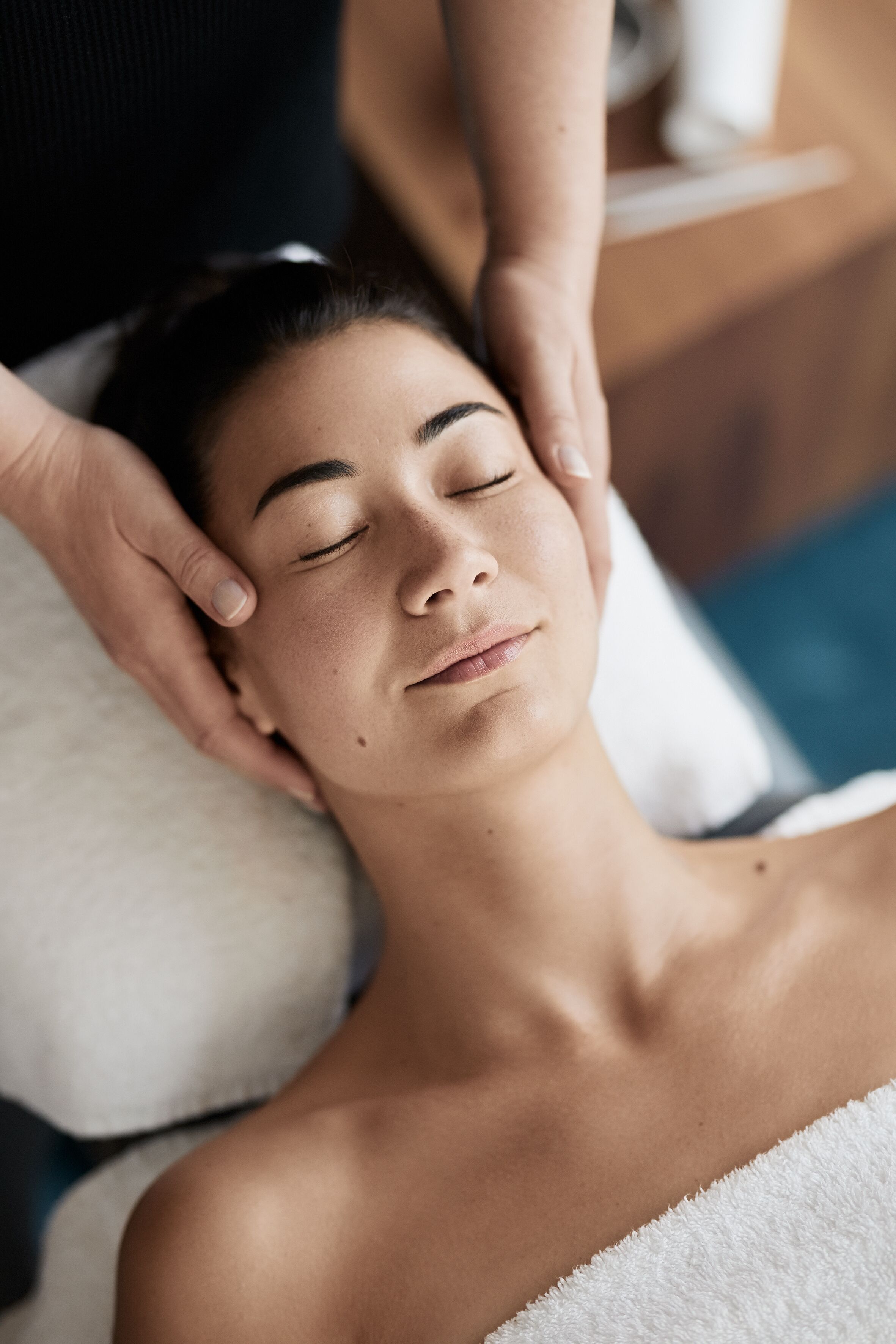 A person receiving a head massage.