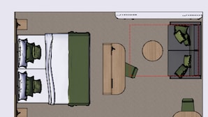 Een kamer met een bed, een bureau, een stoel, een ronde tafel en een bank.