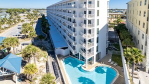 A multi-story hotel with a swimming pool, balconies, and a view of the surrounding area. - ☀️2BR Seacrest 513-Beachfront Complex without Beachfront Prices!☀️ (Fort Walton Beach)