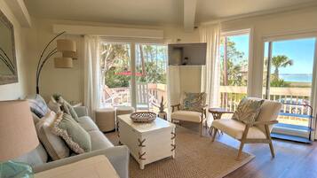 Relax in this inviting living space with a sofa, coffee table, and flat-screen TV.