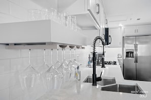 Enjoy cooking in this fully equipped kitchen with an oven, wine rack, and sleek faucet.