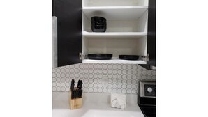 A kitchen with white countertops, a hexagonal tile backsplash, and a black appliance. - Tropical Pardise A (Tampa)