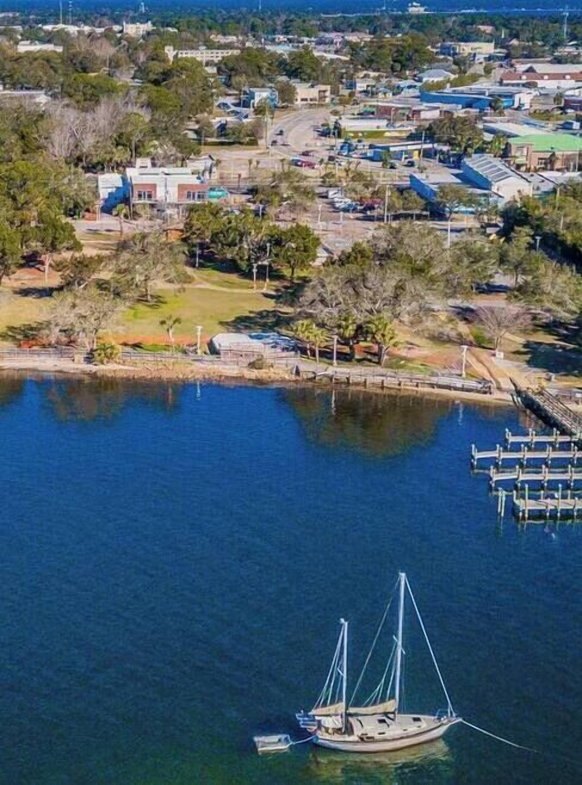 A coastal town with a marina, boats, and residential buildings.