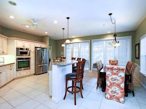 Enjoy cooking and dining in this well-equipped kitchen with a central island and dining area.