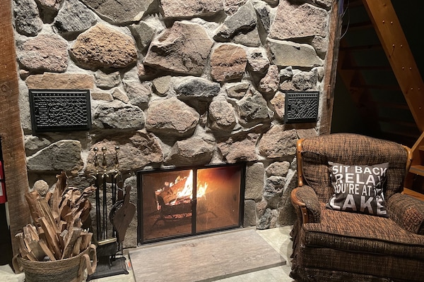 Floor to ceiling natural granite stone fireplace.