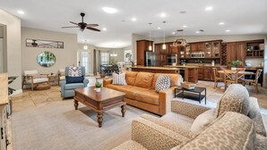 A spacious living room with a sofa, coffee table, and a dining area with chairs. - Double oven | Volleyball Net | 4 Famous Beaches | 1 Level (Sarasota)