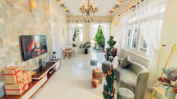 Standard Villa | Living area | 24-inch flat-screen TV with cable channels, TV
