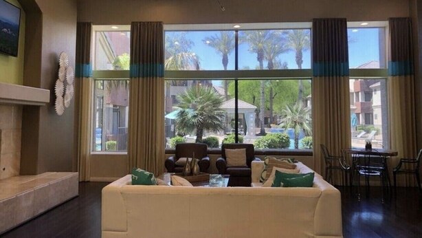 A hotel lobby with a large window, a sofa, chairs, and a table. - 2 Bd/2Ba in Central Phx with a private patio, 2 pools, 2 hot tubs gated complex! (Phoenix)