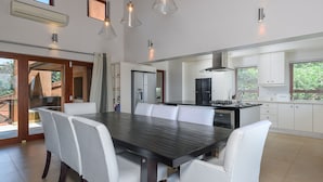 A modern kitchen with a central island, white cabinetry, and pendant lighting. - San Lameer Villa Rentals 1603 (Southbroom)