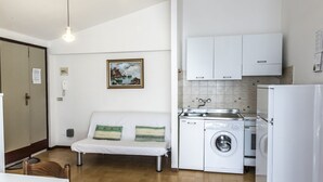 A compact kitchen with a washing machine, a sink, and a white cabinet. - M271 - Marcelli, comfortable two-room apartment with balcony (Marcelli)