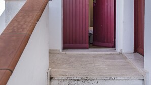 A staircase leading to a room with a red door. - M271 - Marcelli, comfortable two-room apartment with balcony (Marcelli)