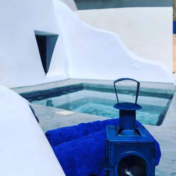 A pool area with a blue towel and a portable heater.