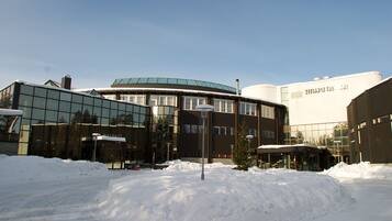 A modern building with large glass windows and a curved facade.