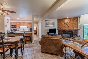 Relax in a welcoming space with a comfortable sofa, dining table, and fireplace.