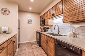 Equipped with a microwave, toaster, and dishwasher, this kitchen offers a convenient cooking space.
