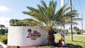 A sign with the text "Point Matanzas 7265" and a palm tree.