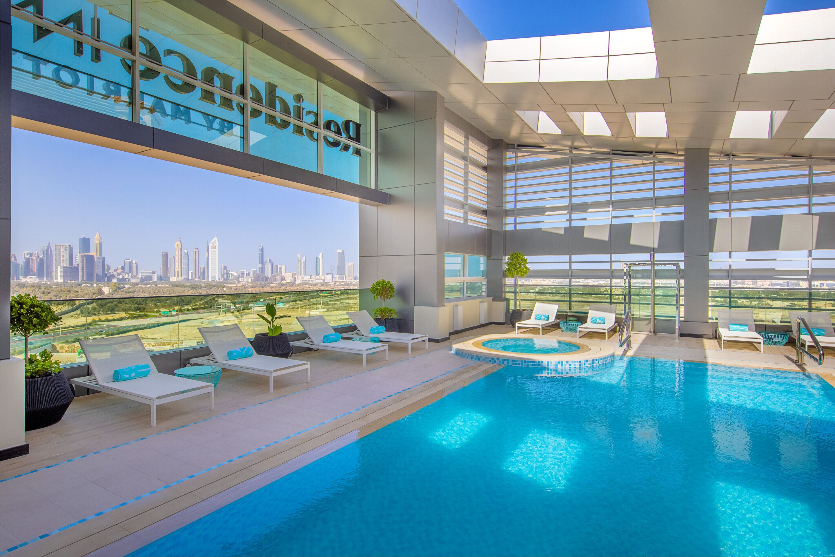 outdoor pool, pool loungers, lifeguards on site