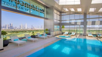 Outdoor pool, pool loungers, lifeguards on site