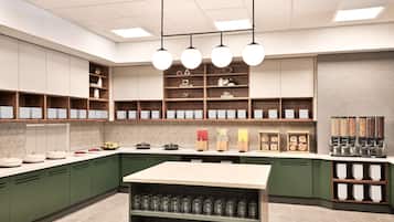 Une cuisine moderne avec des meubles de couleur verte, un îlot central et divers appareils de cuisine.