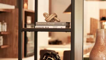 A shelf with books and a decorative object.