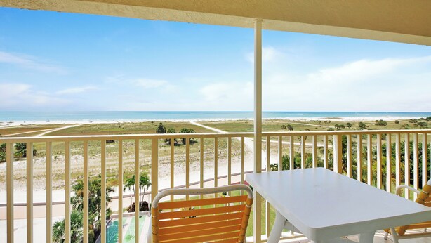 A balcony with a view of a beach and ocean. - Treasure Island Beachfront-Top Floor End Unit  Stunning Sunsets South Beach 601 (Treasure Island)