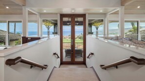 A modern interior with a view of the ocean through large windows.