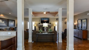 A spacious living area with a fireplace, a sofa, and a coffee table.