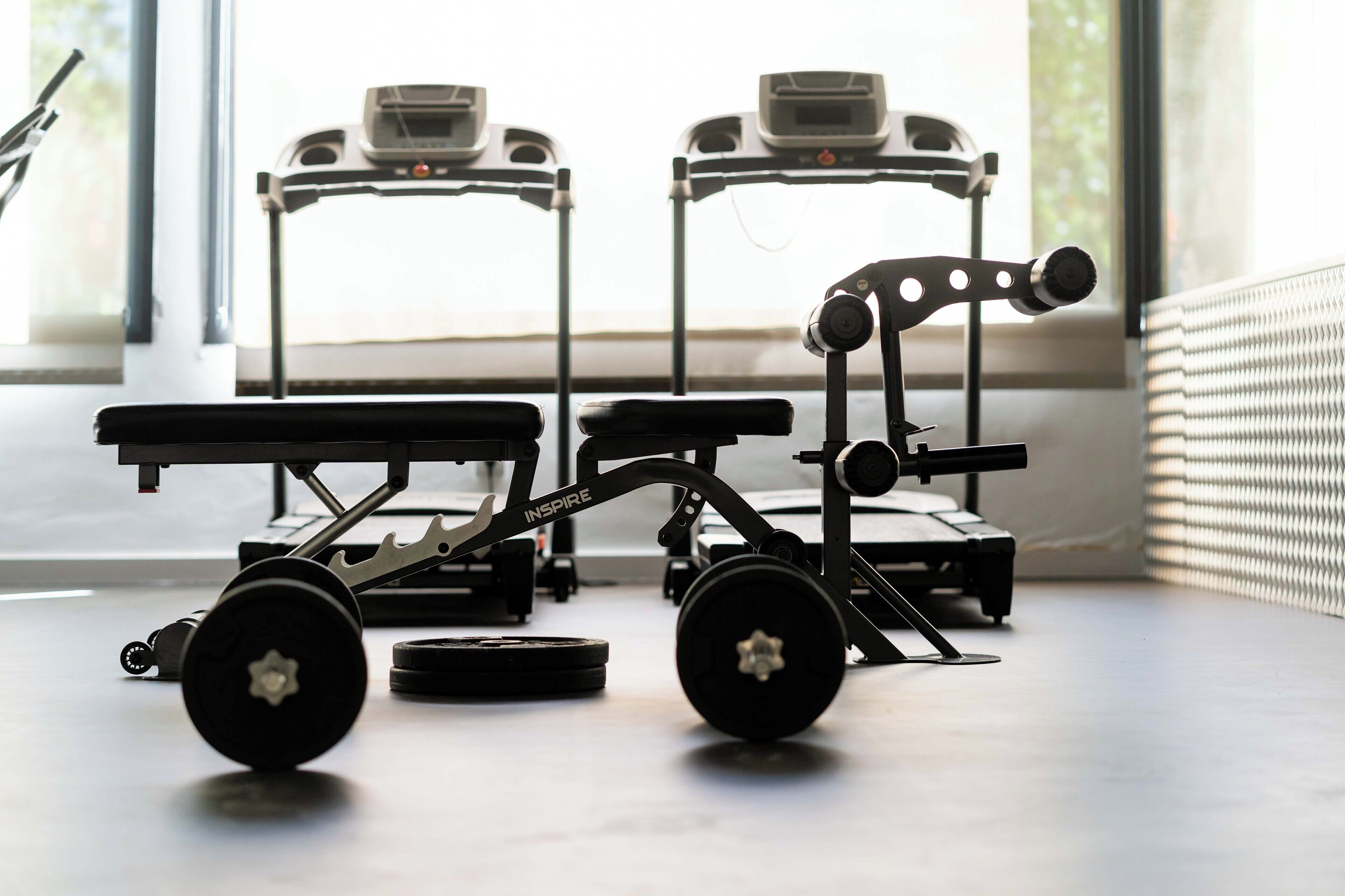 A gym with exercise equipment, including a treadmill and a stationary bike.