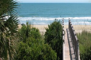 A wooden boardwalk leading to a beach with ocean views. - Cozy 1st Floor Condo at Grand Palms Resort, Near Surfside Beach (Surfside Beach)