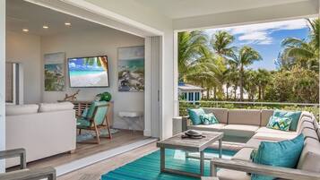 A modern living room with a pool, a sofa set, and a television.