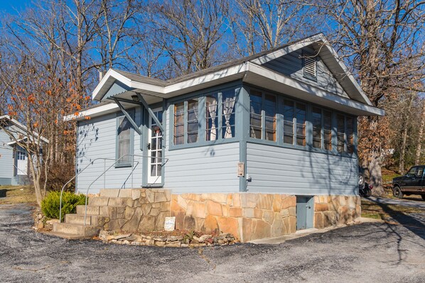 A two-story house with a stone foundation and a blue exterior. - Zen Den at Rockaway Rentals near Branson (Rockaway Beach)
