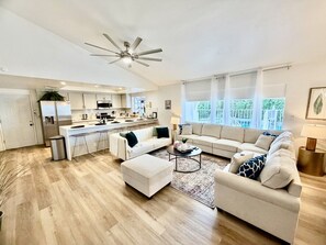 A spacious living area with a sofa set, ottoman, coffee table, and a ceiling fan. - Pvt Oasis Pickleball/Basketball/BBQ/Game Room/Pool (Bermuda Dunes)