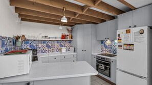 A kitchen with white cabinets, a tiled backsplash, and a stainless steel refrigerator. - Outlook 1 - Unit 1 Narira St 9 (BERMAGUI)