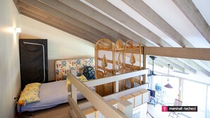 A bedroom with a bed, a window, and a balcony. - Outlook 1 - Unit 1 Narira St 9 (BERMAGUI)