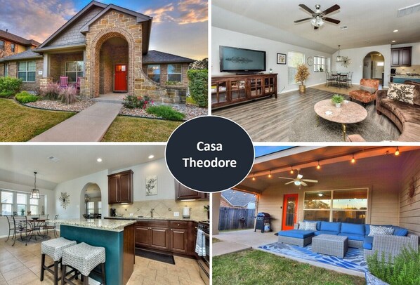 A house with a stone facade, a red door, a dining area with a TV, a kitchen with dark cabinets, a living room with a sofa and a ceiling fan, and a patio with outdoor seating.