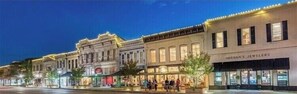 A row of historic buildings with storefronts, including a jewelry store.