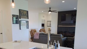 A modern kitchen with a white countertop, stainless steel appliances, and wooden cabinets.