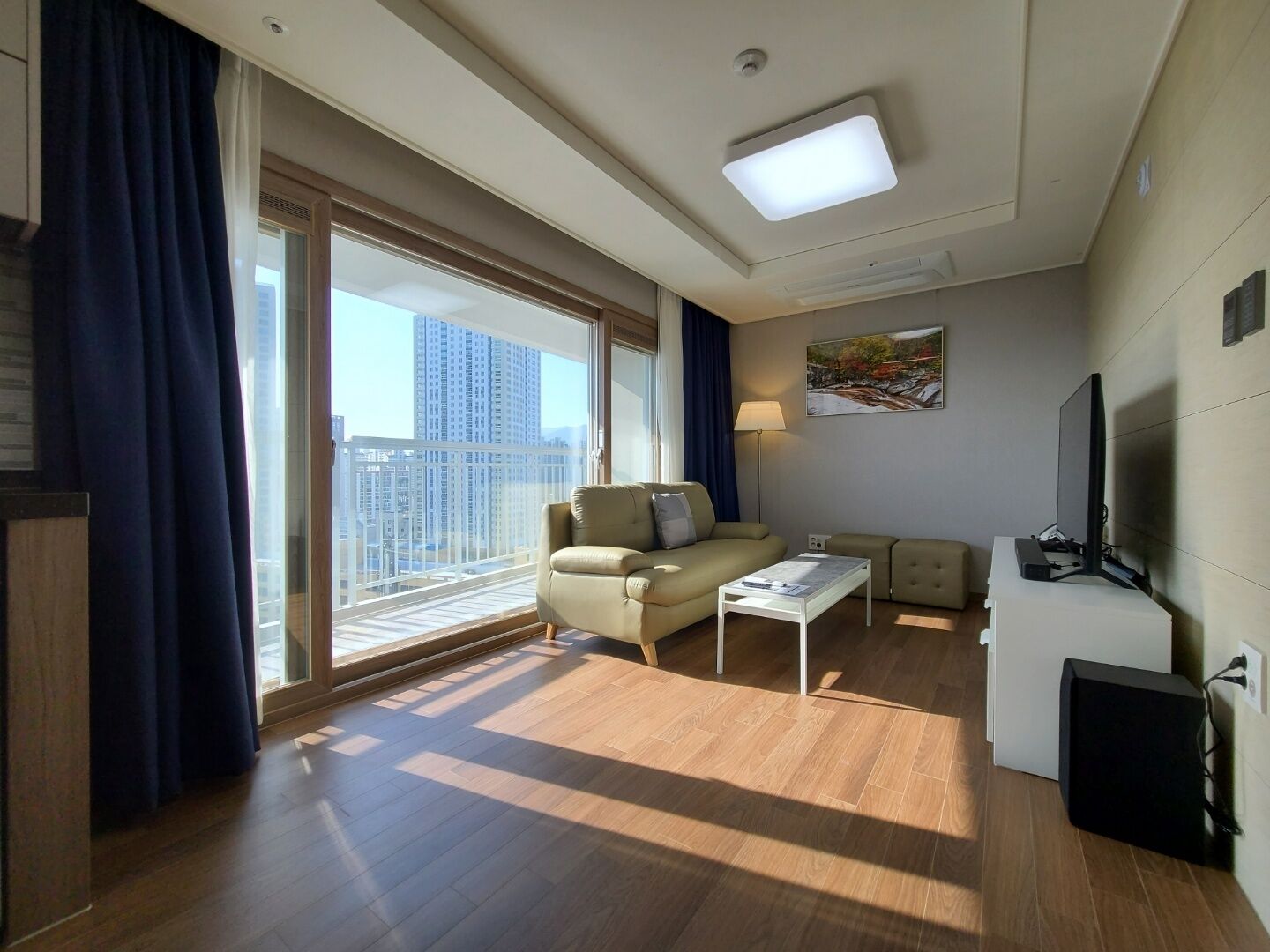 junior suite, multiple beds, non smoking, city view | living area | flat-screen tv, heated floors