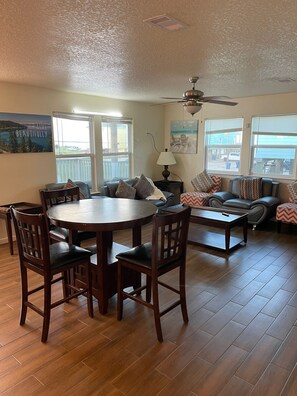 Relax in this inviting living area with a round dining table and comfortable sofa set.