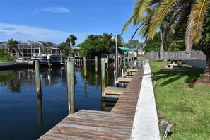 Enjoy waterfront views from the dock, surrounded by lush greenery and a serene atmosphere.
