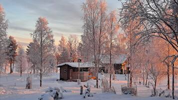 A cabin surrounded by snow-covered trees.