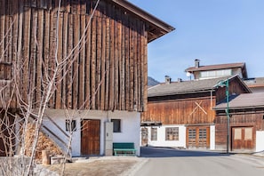 A rustic wooden building with a sloped roof, a bench, and a small window. - Holiday Apartment "Brugger 4 Persons" Near the Ski Area with Mountain View (Kaltenbach)