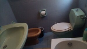 A bathroom with a toilet, bidet, and bathtub. - Room-beautiful Double Room (Taormina)