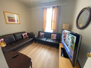 Habitación, 2 habitaciones, para fumadores, patio | Área de sala de estar | Televisión LED y libros