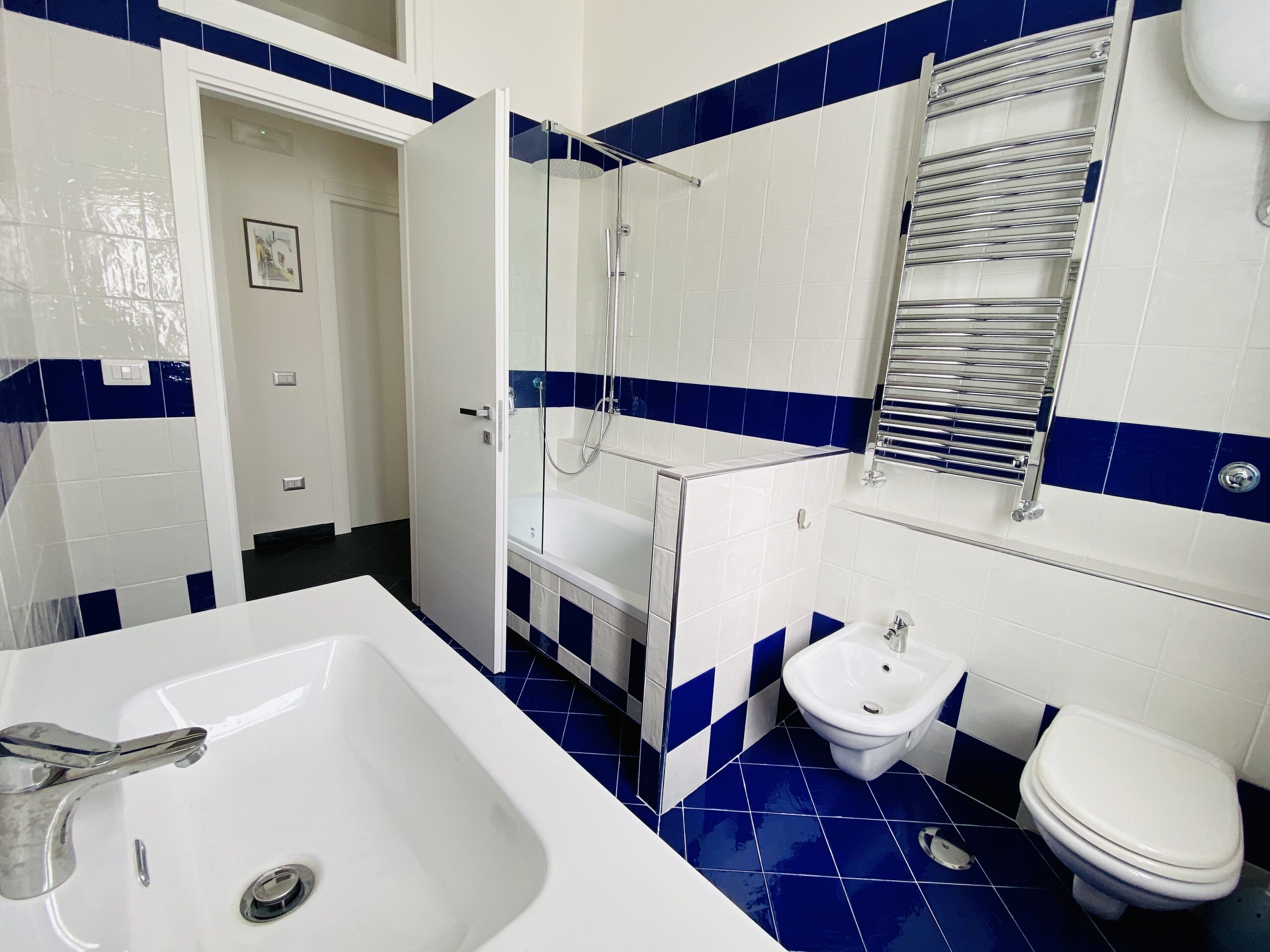 A bathroom with a bathtub, a shower, a sink, and a toilet.