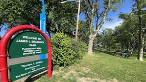 A park sign welcoming visitors to James J. Braddock Park, indicating a playground area managed by Hudson County Division of Parks.